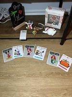 Overview of all items including Christmas character ornaments laid out and boxed Wedgwood ornament.