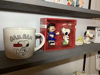 Photo showing Snoopy BAM BAM mug, boxed Lucy & Snoopy salt and pepper shaker set, and Snoopy and Woodstock figurines