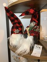 Photo of both plush gnome figures displaying their hats, white faux fur beards, and weighted bases.