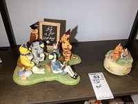Wide view showing the Royal Doulton Winnie the Pooh figurine group along with the resin musical Tigger figure