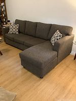 Front view of grey sectional sofa with chaise on right