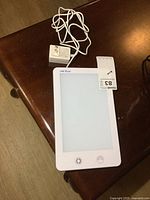 Top view of therapy light panel showing smooth white frame with frosted diffuser and Verilux branding, including attached power adapter and cord.