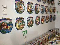 Wall display of 15 Disney Winnie the Pooh collector plates mounted, showing variety of characters and scenes in vibrant colors.