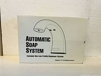 Box showing illustration and name of automatic soap system product