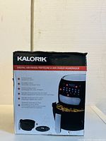 Box of Kalorik Digital Air Fryer showing front with product image and highlighted features including 4.5-quart capacity, LCD screen, 15 cooking presets, adjustable temperature and auto shutoff.