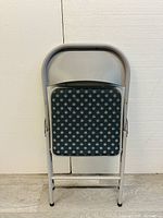 Front view of the foldable chair showing the padded seat and backrest upholstery pattern