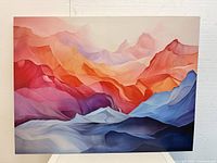 Front view of abstract colorful mountain landscape artwork with smooth gradients in red, pink, orange, purple, blue and white tones on canvas.