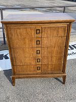 Full view of the wooden dresser showing five drawers and overall design.