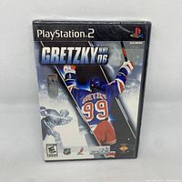 Front cover of Gretzky NHL 06 PlayStation 2 game case showing Wayne Gretzky in hockey gear with number 99 jersey.