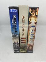 Spine view of three PC game cases: Medieval II Total War, Age of Empires III, Fable The Lost Chapters