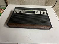 Sears Tele-Games Atari 2600 console front view showing woodgrain finish and control panel with switches and knobs
