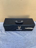 Closed black Husky tool box with handle and latch lock, showing exterior of the box