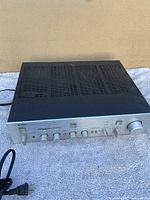 Front angle view of Yamaha A-760 natural sound stereo amplifier, showing black vented top and silver front panel with control knobs.