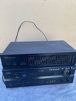 Yamaha RX-V740 receiver and EQ-330 equalizer stacked, showing front and top panel details.