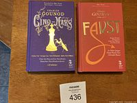Front covers of the two hardcover books: Charles Gounod's Cinq-Mars and Faust, placed side by side, showing title and design details.