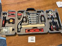 Full view of Durabuilt tool set in gray plastic case showing hammer, pliers, wrenches, screwdrivers, tape measure, and socket set.