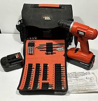 Overall view of the cordless drill, carrying bag, battery pack, and fold-out bit organizer.