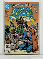 Front cover of Superman and Batman Heroes Against Hunger #1 comic in bag and board, showing the comic cover art with Superman and Batman and starving children.