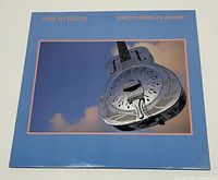 Front cover of Brothers in Arms album showing metallic resonator guitar and blue sky background