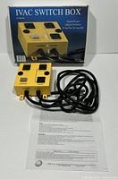IVAC Switch Box yellow device with four outlets, power cords, manual, and original blue box showing product image and details.