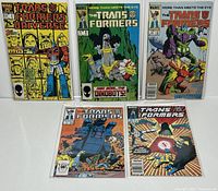 Five Marvel Transformers comic books, issues #2, 8, 10, 27, 61, bagged and boarded, arranged in two rows on a white background.
