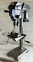 Full front view of Mastercraft bench drill press with base, column, table, and motor housing