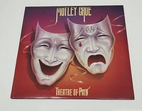 Front cover of Theatre Of Pain album showing theatre masks design