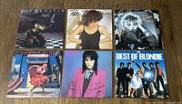 Overview of 6 vinyl albums laid flat showing front covers of Pat Benatar (3), Cyndi Lauper, Joan Jett & The Blackhearts, and Blondie albums.
