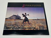 Front cover of the vinyl album showing the artwork with couple dancing and wooden house.