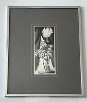 Framed pen and ink artwork centered in the frame with a wide gray mat and silver frame.