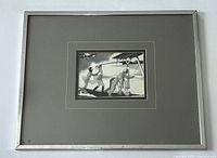 Framed artwork visible on white background showing full piece with grey mat and silver metal frame with minor signs of wear.