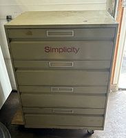 Front view of closed four-drawer cabinet on wheeled cart