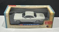 Front and side view of the white 1963 Chevrolet Corvair diecast model in its original Sunstar packaging.