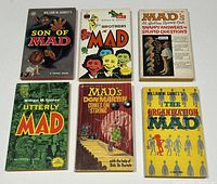Top view of the six Mad Magazine paperback books showing their front covers, arranged in two rows of three, featuring colorful comic art and titles.