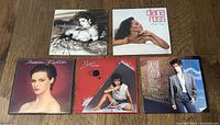 Six vinyl record albums laid out on floor, including Madonna, Diana Ross, and Sheena Easton covers.