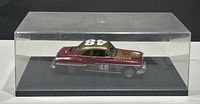 Side view of the diecast car bank model in display case showing maroon and gold paint, race number 48 on roof, Wix Filters logo on hood, and chrome detailing.