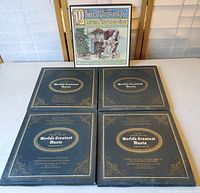 Five vinyl record albums arranged on flat surface, four black 'Basic Library of the World's Greatest Music' albums and one 'White Christmas' album with illustrated Christmas cover