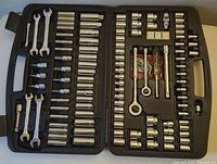 Full view of the Stanley mechanic tool set in an open black plastic case showing sockets, wrenches, and accessories organized in molded slots.