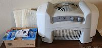 Vornado whole room evaporative humidifier with included accessories displayed on table