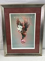 Full view of framed print titled 'Wild Flour Bread' with reddish mat and silver frame showing wear.