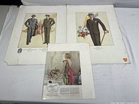 Three mid-century vintage fashion prints laid out on a white surface, two showing men in suits and one showing a woman in a dress, all in full color and vintage style.