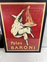 Framed poster full view showing figure in white costume serving pasta on a tray, red background, text 'Pâtes BARONI'.