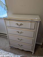 Front full view of white provincial style dresser with five drawers and gold accent handles.