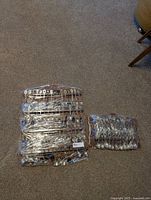 Full view of all spoons on holders wrapped in plastic film, showing the quantity and display method.