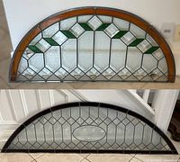 Both stained glass windows stacked one above the other against a white wall