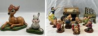 All figurines and fireplace accessory arranged on white background