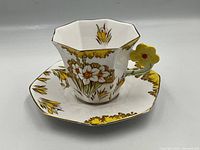 Melba bone china tea cup and saucer with yellow flower handle, floral and corn motifs, gold trim