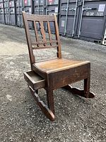 Photo showing full view of wooden Georgian rocking nursing chair from right front angle highlighting side drawer open.