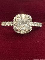 Front view of ring showing princess cut center and halo