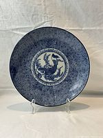Front view of the blue and white serving dish on a stand showing full design